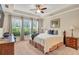 Bright main bedroom with a tray ceiling and large windows at 2920 Farmstead Way, Suwanee, GA 30024