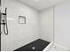 Updated bathroom with a sleek glass-enclosed shower featuring black fixtures and white tile at 5115 Leland Dr, Stone Mountain, GA 30083