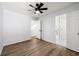 Bright bedroom featuring wood-look floors, ceiling fan, and bathroom access at 5115 Leland Dr, Stone Mountain, GA 30083