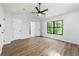 Spacious bedroom with wood-look floors, a ceiling fan, and a large window overlooking greenery at 5115 Leland Dr, Stone Mountain, GA 30083