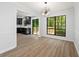 Dining room featuring hardwood floors, modern chandelier, and views to the kitchen and backyard at 5115 Leland Dr, Stone Mountain, GA 30083