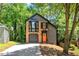 View of the home's exterior showing the brick and siding, set among mature trees and landscaping at 5115 Leland Dr, Stone Mountain, GA 30083