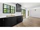 Bright kitchen features stainless steel sink, black cabinets, and dining area perfect for Gathering meals at 5115 Leland Dr, Stone Mountain, GA 30083