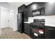 Modern kitchen with black cabinets, stainless steel appliances, and white countertops for a clean, stylish look at 5115 Leland Dr, Stone Mountain, GA 30083