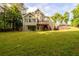 Expansive green backyard with wood deck and patio, perfect for outdoor entertaining at 620 Reeves Hill Pt, Lawrenceville, GA 30043