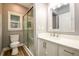 Bright bathroom featuring a glass enclosed shower, toilet, modern vanity, and a framed mirror at 620 Reeves Hill Pt, Lawrenceville, GA 30043