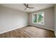 Bright bedroom with light-colored walls, vinyl floors, and a ceiling fan; window to backyard at 620 Reeves Hill Pt, Lawrenceville, GA 30043