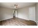 Light, neutral bedroom featuring hard wood floors and a ceiling fan at 620 Reeves Hill Pt, Lawrenceville, GA 30043