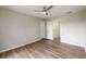 Light and bright bedroom showcasing vinyl floors, ceiling fan, and two-door closet at 620 Reeves Hill Pt, Lawrenceville, GA 30043