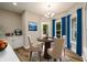 Cozy breakfast nook with table, chairs, built-in cabinets, and bright blue curtains at 620 Reeves Hill Pt, Lawrenceville, GA 30043