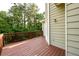 Wood deck offers a view of the verdant wooded back yard of the home at 620 Reeves Hill Pt, Lawrenceville, GA 30043