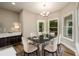 Dining room with marble table, upholstered chairs, sideboard and natural light at 620 Reeves Hill Pt, Lawrenceville, GA 30043