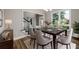 Dining room with modern chandelier, large window, dark table and view of the front entry at 620 Reeves Hill Pt, Lawrenceville, GA 30043
