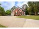 A lovely brick home with an attached garage and a large, well-maintained front lawn at 620 Reeves Hill Pt, Lawrenceville, GA 30043