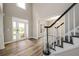 Bright foyer with elegant staircase and hardwood floors, creating a grand entrance at 620 Reeves Hill Pt, Lawrenceville, GA 30043