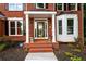 Welcoming front porch with brick steps and decorative planters at the entrance at 620 Reeves Hill Pt, Lawrenceville, GA 30043