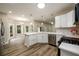 Bright kitchen features white cabinetry, stainless steel appliances, and a large island with quartz countertops at 620 Reeves Hill Pt, Lawrenceville, GA 30043