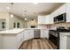 Spacious kitchen with stainless steel appliances, island with white countertop, and hardwood floors at 620 Reeves Hill Pt, Lawrenceville, GA 30043