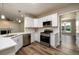 Well appointed kitchen featuring stainless steel appliances, modern backsplash, and large sink at 620 Reeves Hill Pt, Lawrenceville, GA 30043