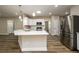 Modern kitchen features a large island, stainless steel appliances, and white cabinetry at 620 Reeves Hill Pt, Lawrenceville, GA 30043
