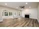 Open-concept living room with fireplace, modern lighting, and spacious layout at 620 Reeves Hill Pt, Lawrenceville, GA 30043