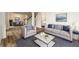 Open living room with hardwood floors, a modern seating arrangement, and an adjacent dining area at 620 Reeves Hill Pt, Lawrenceville, GA 30043