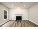 Bright living room features hardwood floors, a fireplace, and a large window at 620 Reeves Hill Pt, Lawrenceville, GA 30043