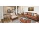 Comfortable living room featuring hardwood floors and a cozy seating arrangement with fireplace at 620 Reeves Hill Pt, Lawrenceville, GA 30043