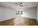 Bright main bedroom features a tray ceiling, ceiling fan, and natural light at 620 Reeves Hill Pt, Lawrenceville, GA 30043