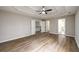 Large main bedroom with tray ceiling, ceiling fan, ensuite bathroom and stairway access at 620 Reeves Hill Pt, Lawrenceville, GA 30043