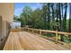 A spacious back deck with wood floors and railings overlooking a wooded backyard at 681 Fielding Sw Ln, Atlanta, GA 30311