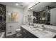 Elegant bathroom with dual sinks, marble countertops, luxurious fixtures, and a soaking tub at 681 Fielding Sw Ln, Atlanta, GA 30311