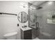 Modern bathroom with tiled glass shower, round mirror, updated sink, and contemporary fixtures at 681 Fielding Sw Ln, Atlanta, GA 30311