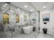Modern bathroom featuring a glass shower, marble walls, sleek fixtures, and a luxurious soaking tub at 681 Fielding Sw Ln, Atlanta, GA 30311