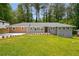 Charming single-story home featuring a well-manicured lawn and newly planted landscaping at 681 Fielding Sw Ln, Atlanta, GA 30311