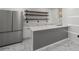 Kitchenette featuring a modern stainless fridge, sink, white cabinets, and floating wood shelves at 681 Fielding Sw Ln, Atlanta, GA 30311