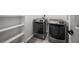 Laundry room featuring two new modern gray washing machines with built-in white shelving at 681 Fielding Sw Ln, Atlanta, GA 30311