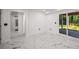 Bright living room with marble floors and sliding glass doors to the outside at 681 Fielding Sw Ln, Atlanta, GA 30311
