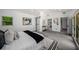 Bright main bedroom with a walk-in closet, doors to the outdoor patio, and access to the luxurious main bathroom at 681 Fielding Sw Ln, Atlanta, GA 30311