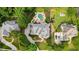 Aerial view of a luxurious home showcasing the pool, patio, landscaping, and surrounding neighborhood at 7025 Kettering Ln, Suwanee, GA 30024