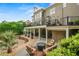 A backyard with multiple levels, stone accents, a pool, a covered patio, and lush landscaping for private outdoor living at 7025 Kettering Ln, Suwanee, GA 30024