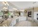 Spacious bathroom with granite countertops and plenty of mirror and counter space at 7025 Kettering Ln, Suwanee, GA 30024