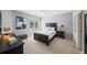 Comfortable bedroom with neutral tones, a ceiling fan, a window for natural light, and a bed with bedside tables at 7025 Kettering Ln, Suwanee, GA 30024