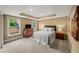 Bedroom with tray ceiling, neutral walls, and view of fenced yard and trees at 7025 Kettering Ln, Suwanee, GA 30024