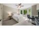 Bright bedroom featuring neutral tones, a comfortable bed, and large windows with a view of the neighborhood at 7025 Kettering Ln, Suwanee, GA 30024