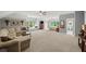 Expansive bonus room with a seating area, a bed, ample natural light, and versatile space for recreation at 7025 Kettering Ln, Suwanee, GA 30024