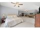 Large, well-lit bonus room featuring a comfortable bed, a cozy seating area, and ample space for relaxation at 7025 Kettering Ln, Suwanee, GA 30024
