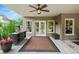 A covered patio with a ceiling fan, a wet bar, and a view of the pool, providing a perfect outdoor space at 7025 Kettering Ln, Suwanee, GA 30024