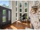 Elegant foyer with soaring windows, stone accents, piano, and hardwood floors at 7025 Kettering Ln, Suwanee, GA 30024