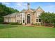Inviting home with a manicured lawn, stone accents, and a grand entrance at 7025 Kettering Ln, Suwanee, GA 30024